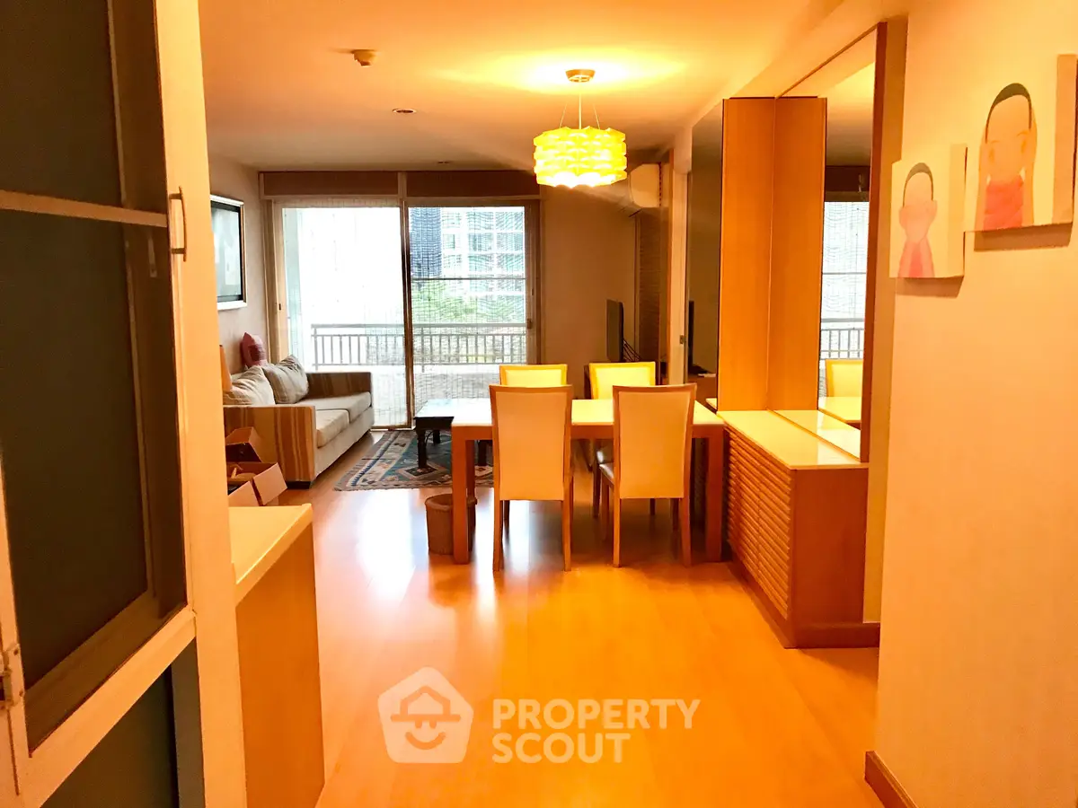 Spacious living room with modern decor and large windows offering natural light.