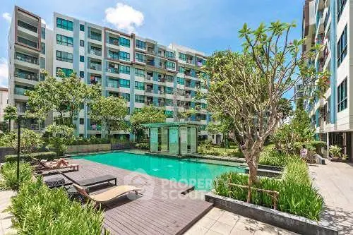 Luxurious apartment complex with a stunning outdoor pool and lush greenery, perfect for relaxation and leisure.