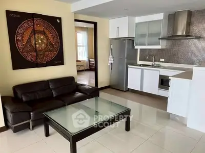 Modern open-plan living room with sleek kitchen and stylish decor