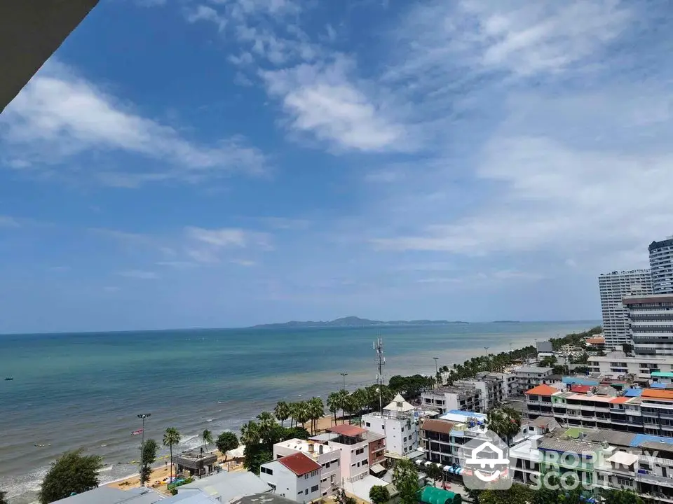 Stunning coastal view from high-rise building overlooking ocean and cityscape.