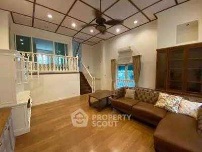 Spacious living room with elegant wooden flooring and cozy seating area