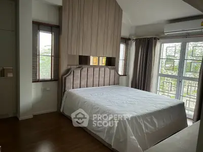 Spacious bedroom with large windows and modern decor