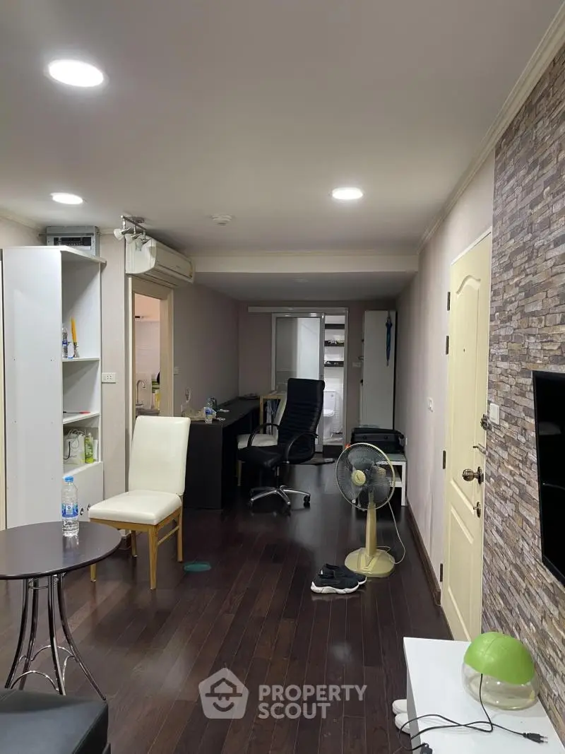 Modern apartment interior with dark wood flooring and stylish furniture