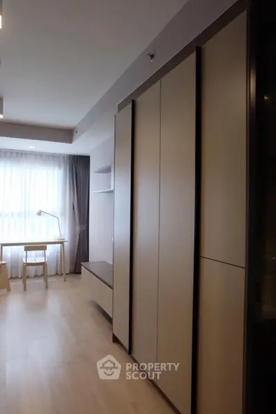 Modern bedroom with large wardrobe and study desk by window