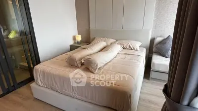 Modern bedroom with stylish decor and cozy ambiance, featuring a comfortable bed and elegant furnishings.