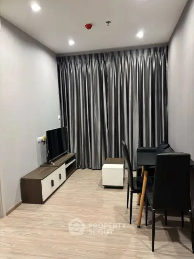 Modern living room with sleek furniture and elegant curtains