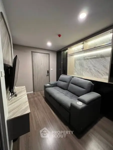 Modern living room with sleek design and cozy sofa in a stylish apartment.