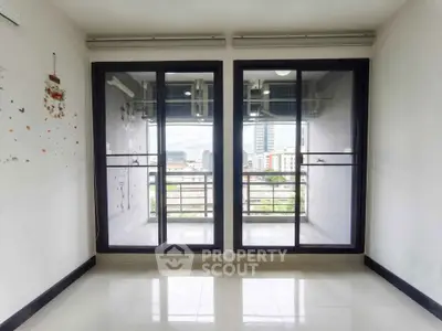 Bright room with large windows and city view, perfect for modern living.