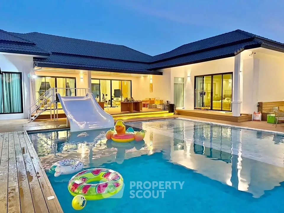 Luxurious villa with private pool and slide, perfect for family fun and relaxation.