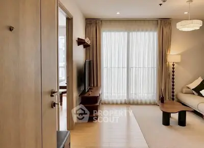 Modern living room with natural light, wooden flooring, and elegant decor in a stylish apartment.