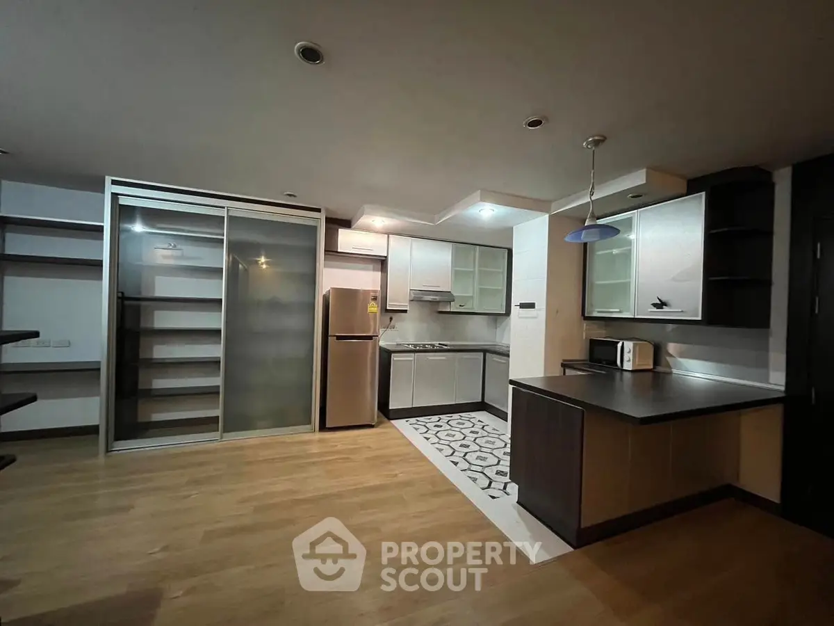 Modern kitchen with sleek cabinetry and stainless steel appliances in open layout