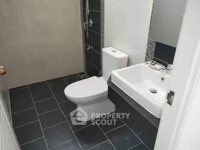 Modern bathroom with sleek black tiles and contemporary fixtures