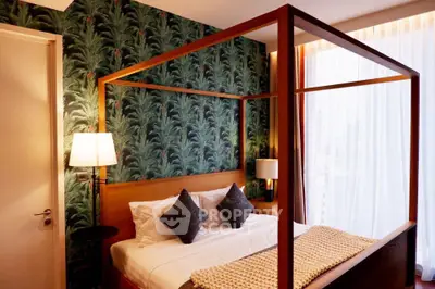 Luxurious bedroom with elegant four-poster bed and stylish wallpaper, perfect for a serene retreat.