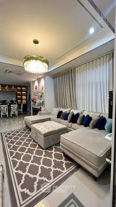 Luxurious living room with elegant chandelier and plush sectional sofa