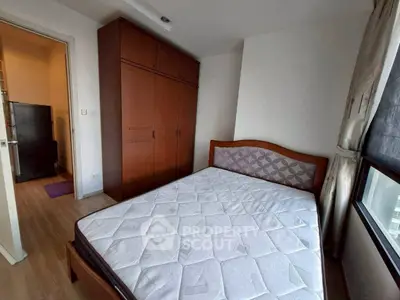 Cozy bedroom with wooden wardrobe and large window for natural light