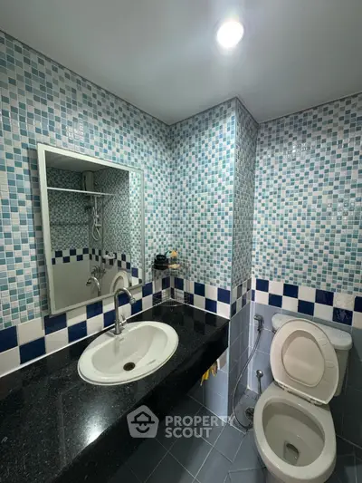 Modern bathroom with stylish blue mosaic tiles and sleek fixtures