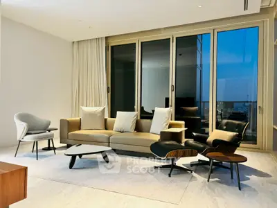 Luxurious modern living room with elegant furniture and large windows offering stunning views.