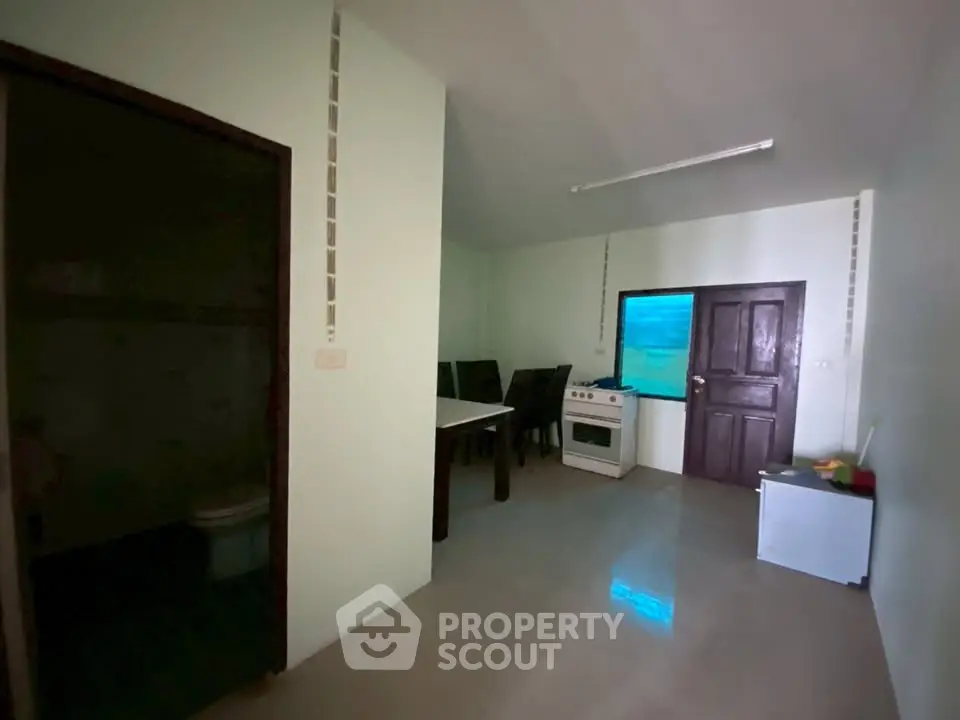 Cozy kitchen with dining area and modern appliances in a compact layout.