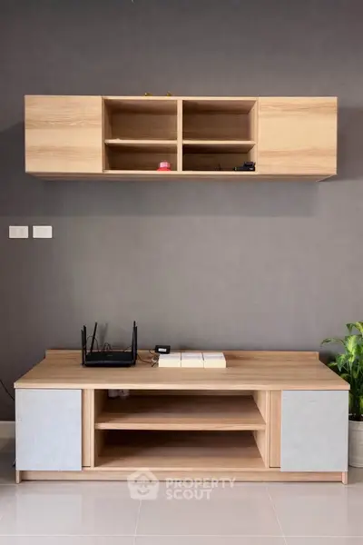 Modern living room with stylish wooden entertainment unit and sleek decor