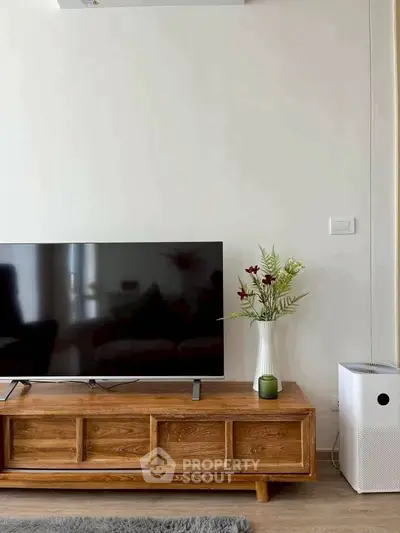 Modern living room with sleek TV stand and air purifier, perfect for contemporary living.