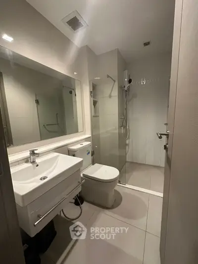 Modern bathroom with sleek fixtures and glass shower enclosure