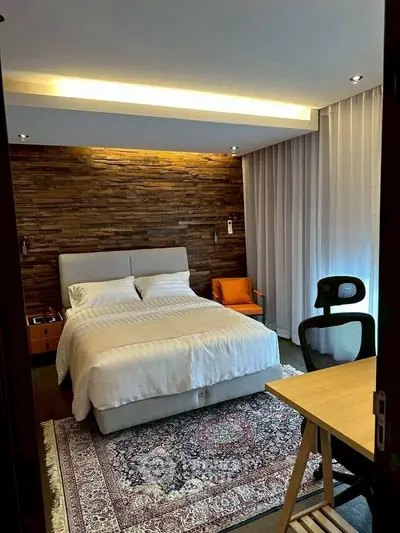 Cozy bedroom with wooden accent wall and modern furniture