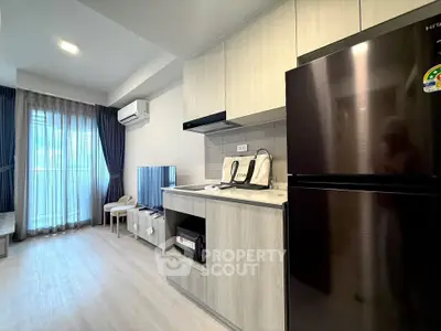 Modern living room with sleek kitchen and balcony view in stylish apartment