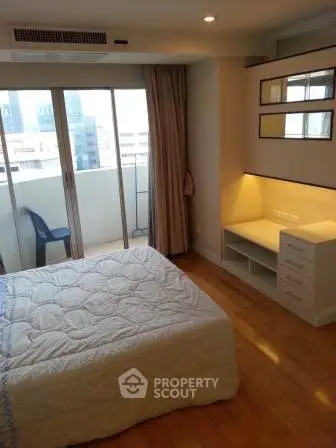 Cozy bedroom with balcony access in modern apartment