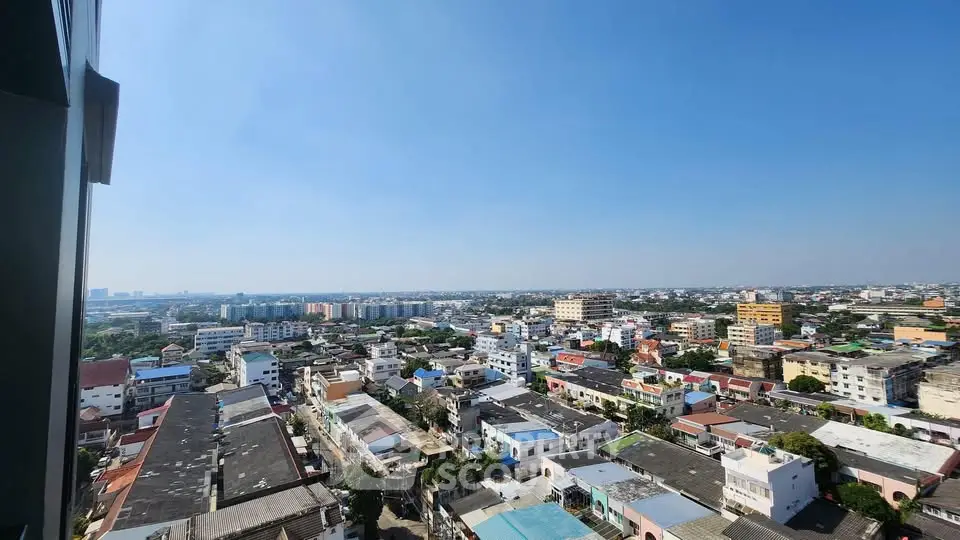 Stunning panoramic cityscape view from high-rise apartment balcony.