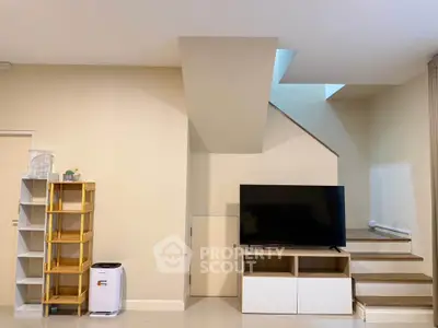 Modern living room with sleek TV setup and stylish shelving