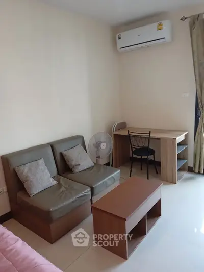Cozy living room with modern furniture and air conditioning in a stylish apartment.