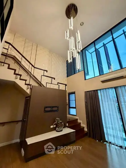 Stunning modern living room with high ceilings and elegant staircase