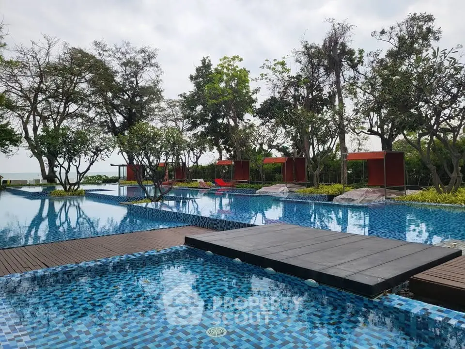 Luxurious outdoor pool area with lush greenery and modern design, perfect for relaxation and leisure.