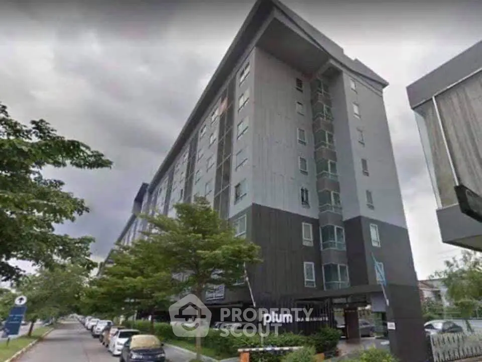 Modern apartment building with sleek design and ample parking space