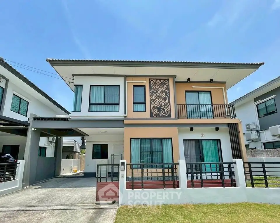 Modern two-story house with unique facade design and spacious driveway.