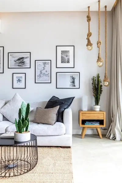 Stylish living room with modern decor, cozy sofa, and unique hanging lights.