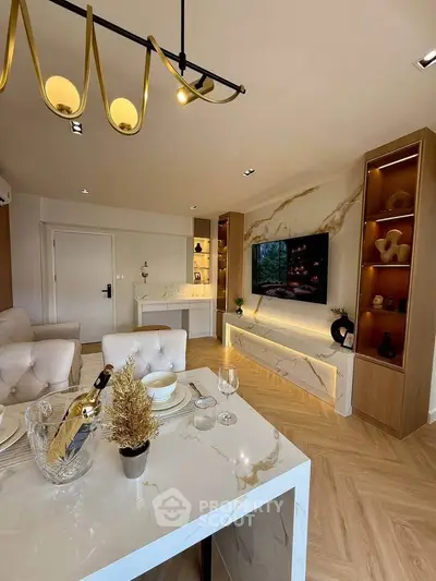 Luxurious modern living room with elegant decor and marble accents, featuring a stylish dining area and built-in TV unit.