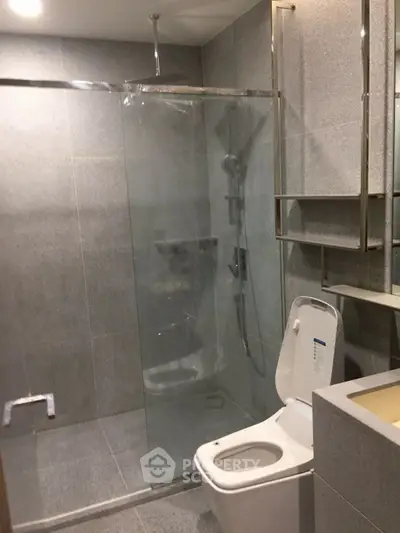 Modern bathroom with glass shower and sleek fixtures in a contemporary home.