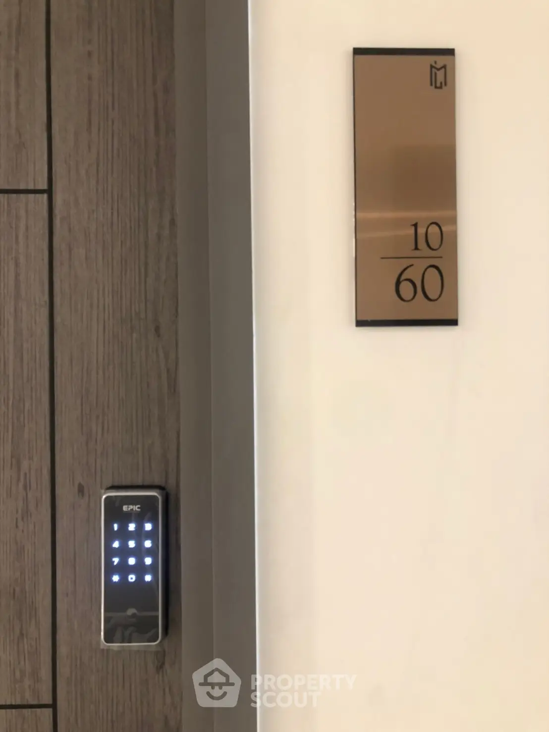 Modern apartment entrance with digital lock and stylish room number plaque.