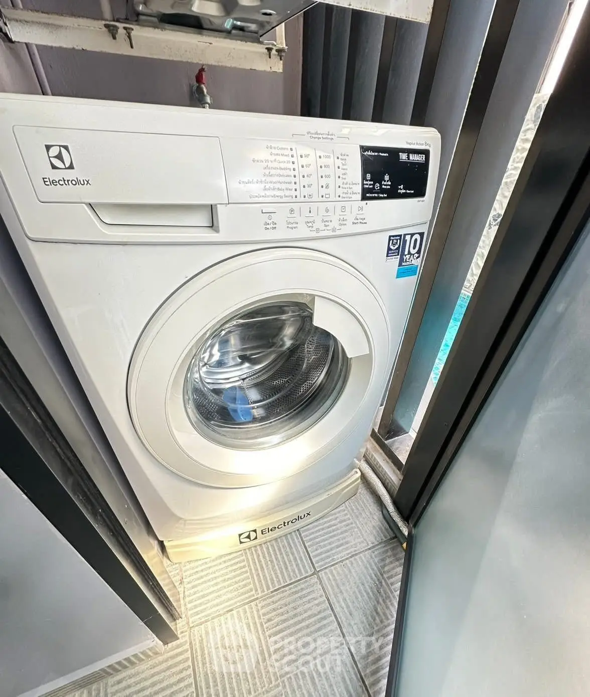 Modern washing machine in a sleek laundry area with natural light