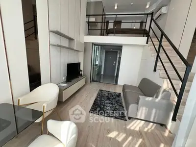 Modern loft-style living room with mezzanine and sleek furnishings