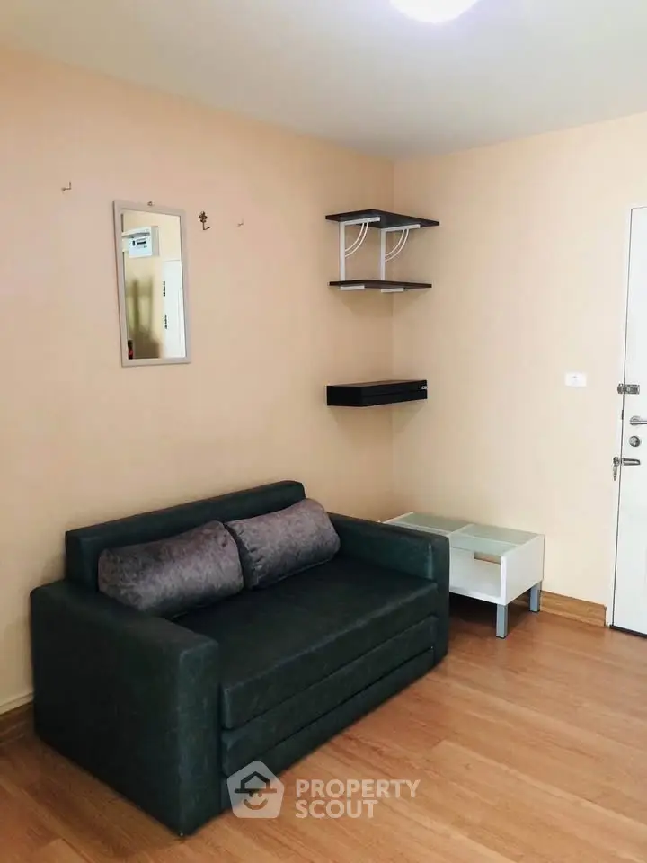 Cozy living room with modern sofa and wall shelves in a stylish apartment.