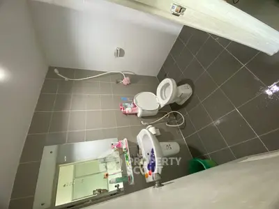 Modern bathroom with sleek tiles and essential fixtures