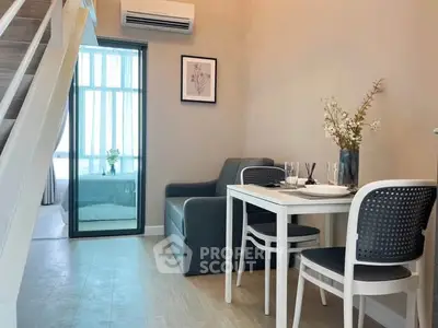 Modern living room with dining area and staircase in stylish apartment