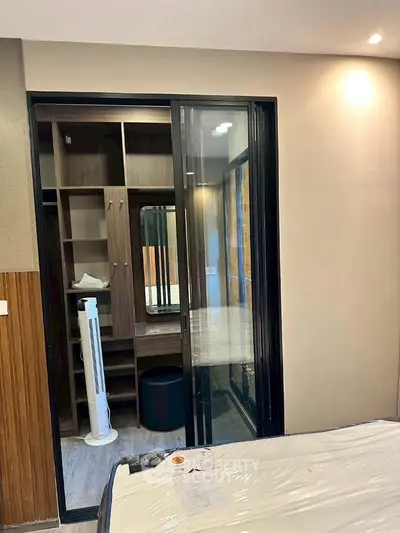 Modern bedroom with sliding glass door and built-in closet