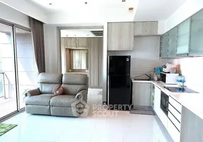 Modern open-layout kitchen with sleek appliances and cozy seating area.