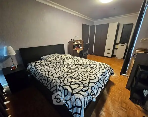 Spacious bedroom with modern decor and ample storage space