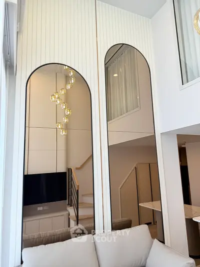 Modern living room with elegant lighting and stylish staircase