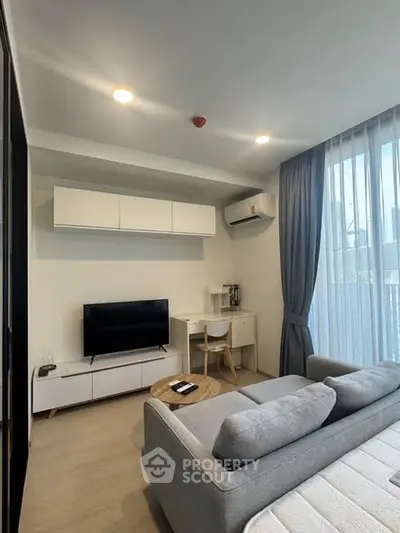 Modern living room with sleek furniture and natural light, perfect for urban living.