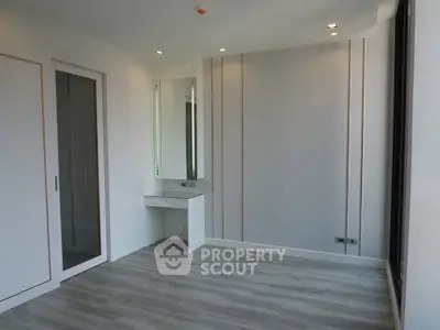 Modern minimalist bedroom with sleek flooring and built-in closet